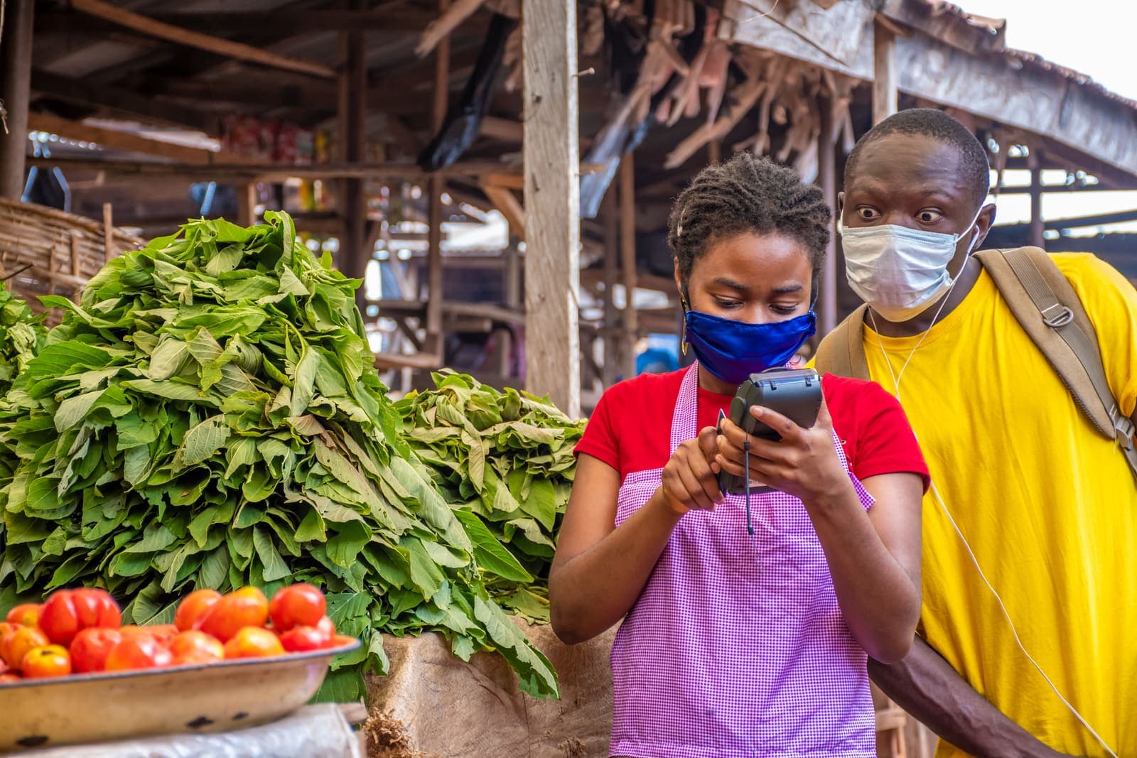 A market trader taking a payment on a POS machine
