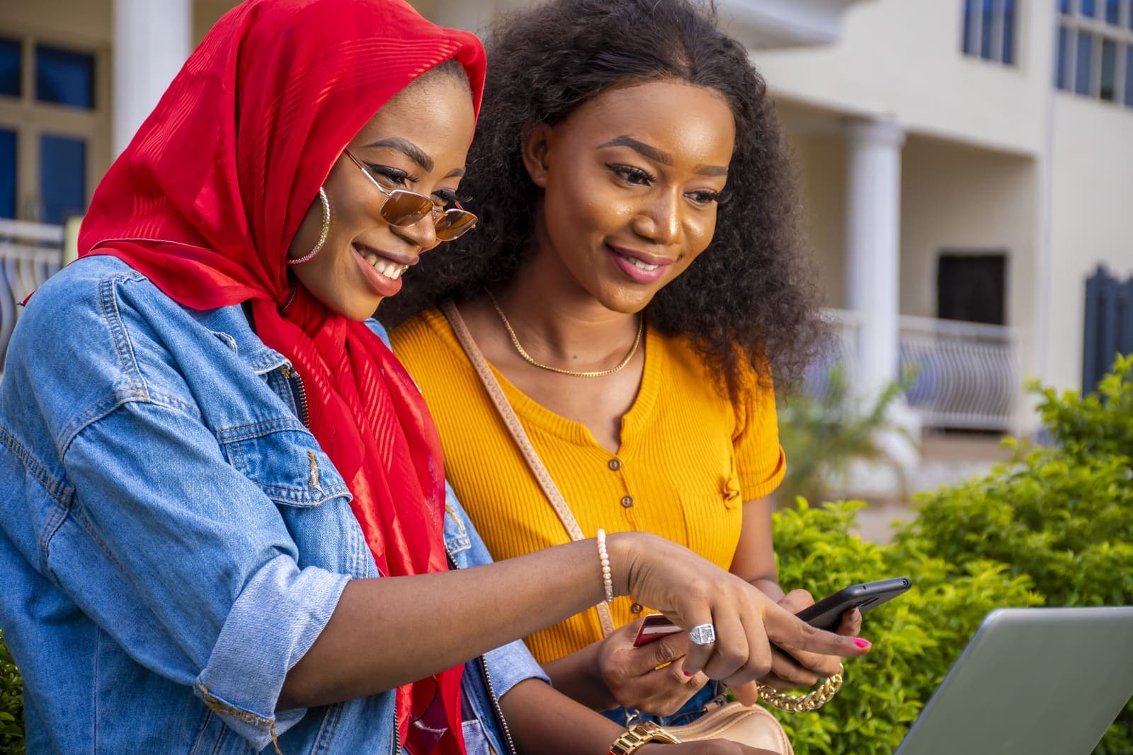 Two young women checking sales on a phone